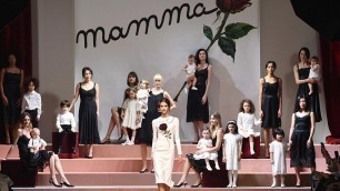 'Models walk the runway cradling BABIES during Dolce & Gabbana show at Milan Fashion Week'