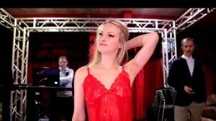 'Skinny girl walks the catwalk in a red negligee with g string panties'